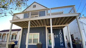 A two-story house with a balcony and a nameplate reading "JOSEPH ST."