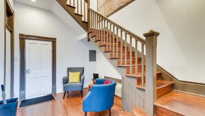 A staircase with wooden steps and a handrail, leading to an upper floor.