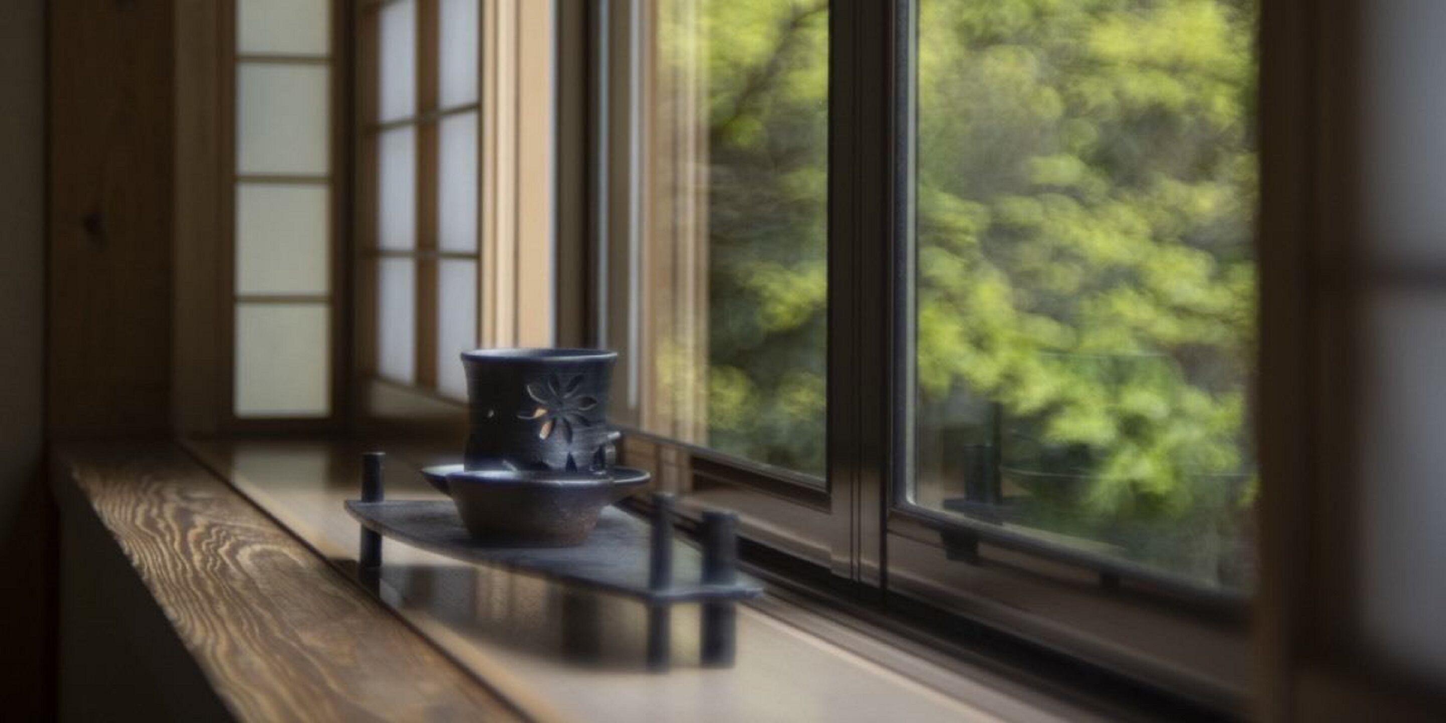 A window with a view of trees outside.