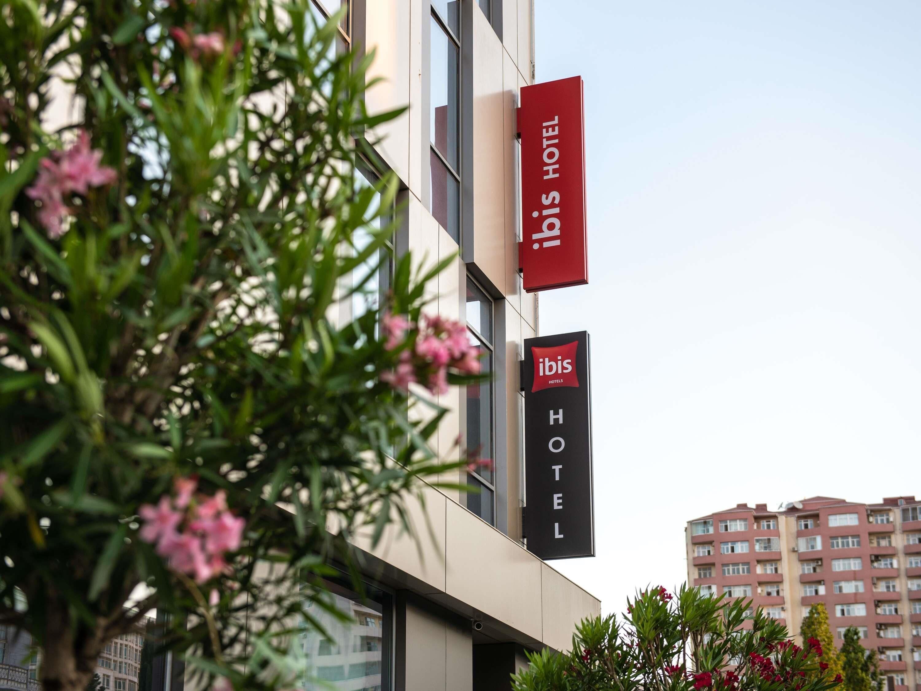 A hotel sign with 'ibis HOTEL' and a building facade.