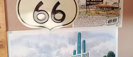 A vintage Texas 66 sign, a welcome sign to McLean, and a Cactus Inn motel illustration.