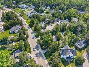 An aerial view of a residential area with multiple houses, roads, and greenery. - Cabin in Downtown Ephraim-Perfect for couples! (Ephraim)