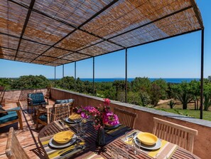 Enjoy al fresco dining with ocean views and lush surroundings.