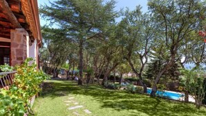 A well-maintained garden with a stone pathway leading to a pool area. - La Plaza by Interhome (Calonge)
