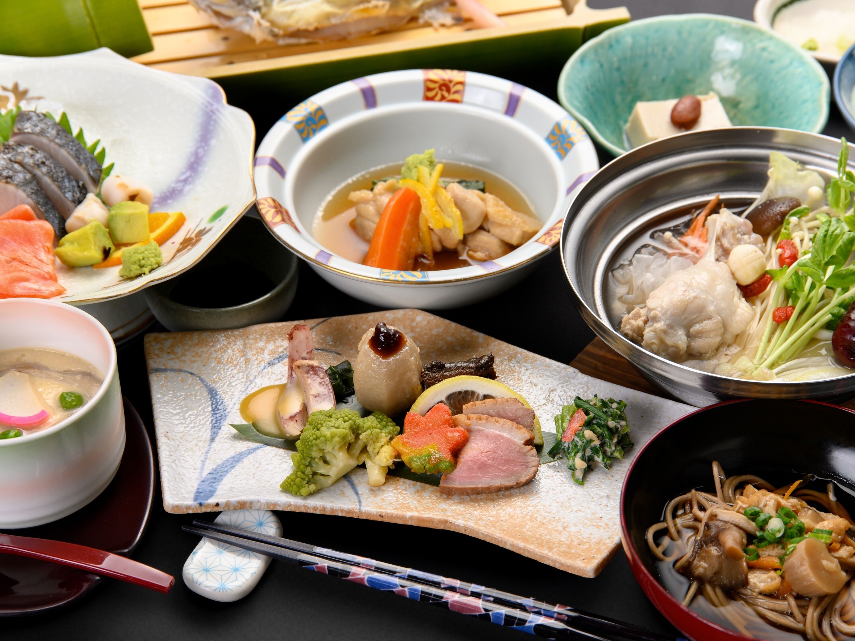 A variety of dishes on a table, including seafood, vegetables, and meat, suggesting a meal setting.