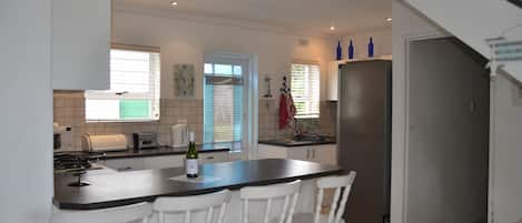 Cottage, Beachside | Private kitchen | Fridge, microwave, oven, stovetop