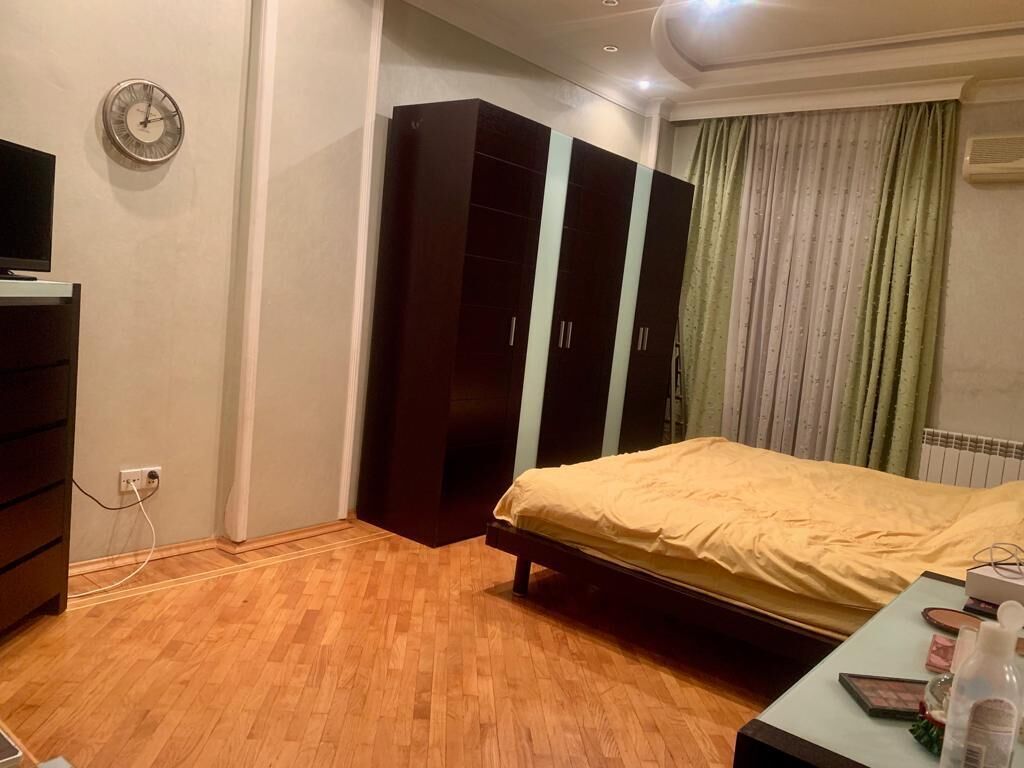 A bedroom with a bed, wardrobe, and a TV.