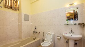 A bathroom with a bathtub, toilet, and sink. - Hotel Marigold (Mahamanjushree Nagarkot)