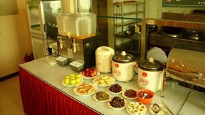A buffet setup with various food items, a coffee station, and a microwave. - Greentree Inn Beijing Daxing District Yufa Town Ne (Daxing)