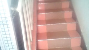 A staircase with red steps and metal railings, leading upwards. - Famouse Guest House (Nairobi)