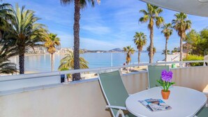 A balcony with a table, chairs, and a potted plant. - Rocamar by Interhome (Calpe/Calp)