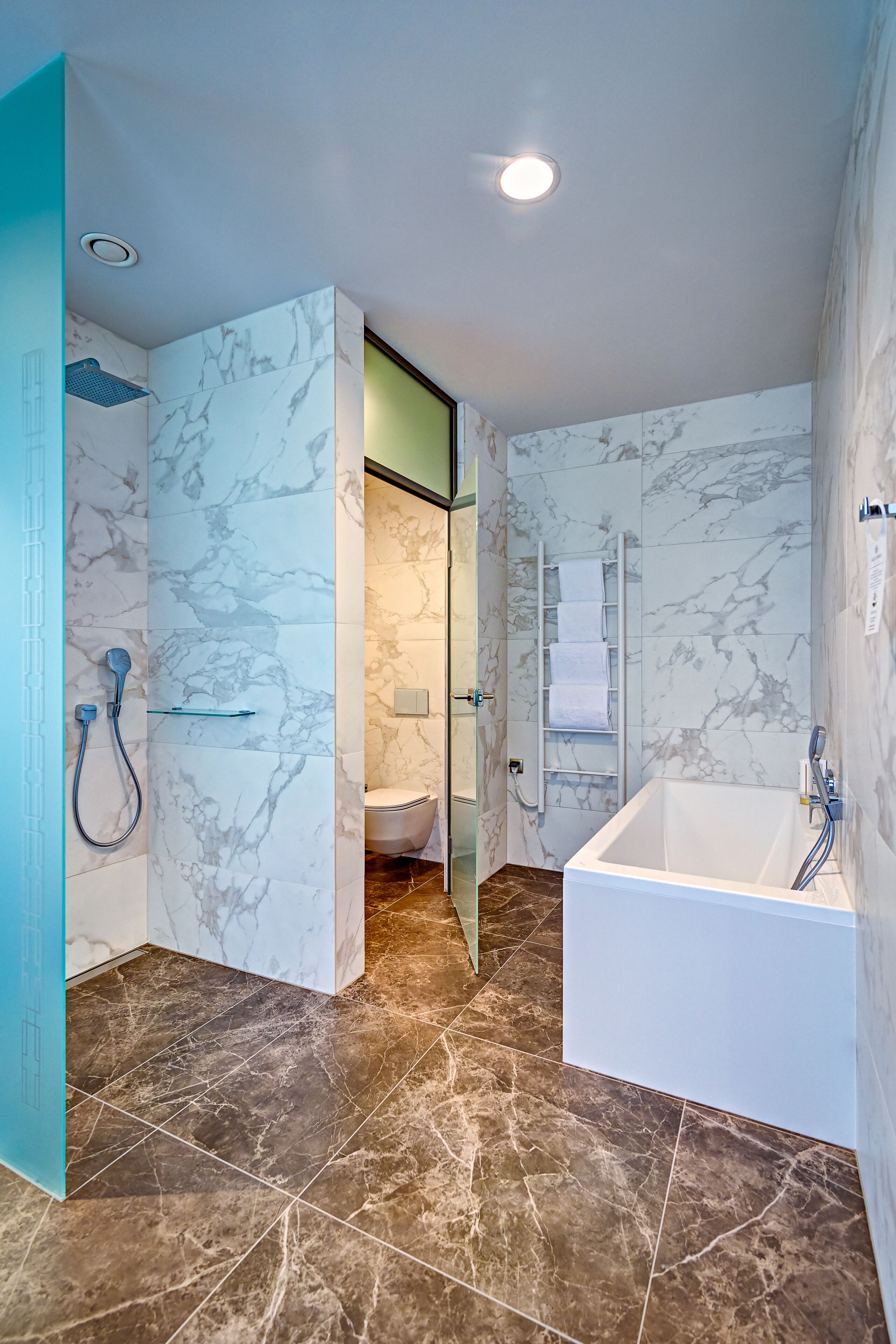 premium studio suite | bathroom | hair dryer, towels, soap, shampoo