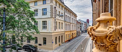Vista de una calle con edificios, un tranvía y automóviles estacionados.