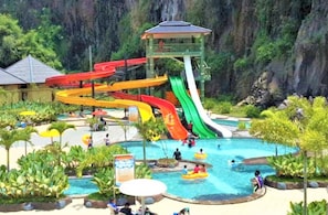 A water park with multiple slides, a pool area, and a lookout tower. - Pesona Nirwana Resort by Zuzu (Soreang)