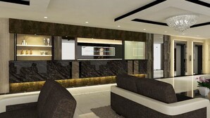 A modern living area with a sofa, a flat-screen TV, and a decorative wall. - Hotel Anika (Kluang)