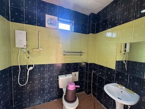 A bathroom with a toilet, bidet, sink, and a towel rack. - Mersing Beach Resort (Mersing)