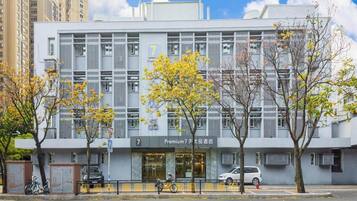 A modern building with a storefront labeled 'Premium 7' and a bicycle parked outside.