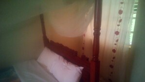 A single bed with a wooden headboard and a white pillow. - Soulfa Guest House (Nairobi)