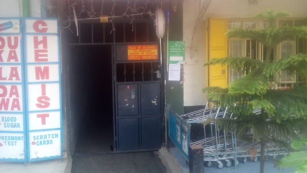 A storefront with a neon sign reading "SOULFA" and a sign prohibiting the sale of alcohol to persons under 18 years. - Soulfa Guest House (Nairobi)