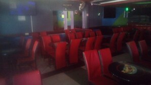 A dimly lit restaurant with red seating and a Viceroy sign on the wall. - Soulfa Guest House (Nairobi)