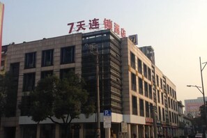A multi-story building with a prominent sign at the top.