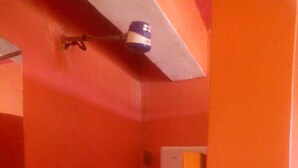 A bathroom with a sink, toilet, and shower area. - Jambo Guest House (Nairobi)