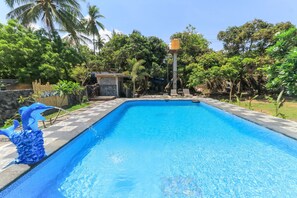 A rectangular swimming pool with a clear blue water surface, surrounded by a stone border. - Hotel Tara Bar & Resto Air Sanih (Kubutambahan)