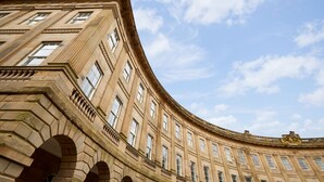 A curved building with multiple windows and arches. - Buxton Crescent (Buxton)