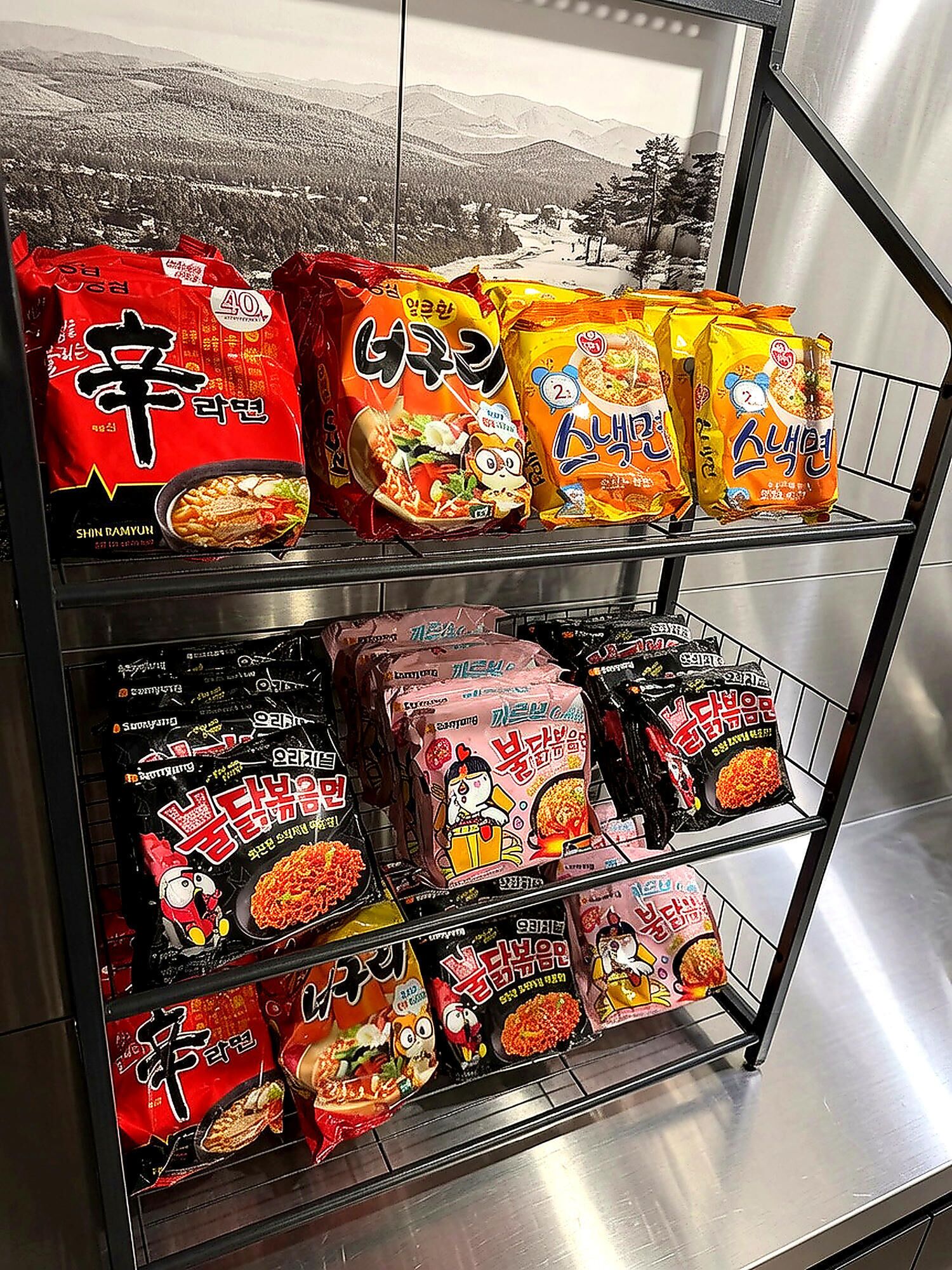 A shelf stocked with various packaged food items, likely in a store or market setting.