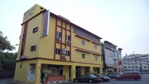 A yellow building with a sign that reads "HOTEL" and multiple air conditioning units. - Oyo 424 Kk Inn Hotel (Ampang)