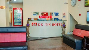 A hotel reception area with a Coca-Cola refrigerator, a clock, and a reception desk. - Oyo 424 Kk Inn Hotel (Ampang)