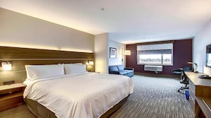 A hotel room with a large bed, a desk, a chair, and a window with a view. - Holiday Inn Express & Suites Calgary Airport Trail NE by IHG (Calgary)