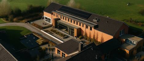 A modern two-story house with a large garage, a covered driveway, and a well-maintained lawn.