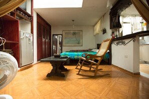 Cozy living space with a central seating area, bed, and kitchenette.