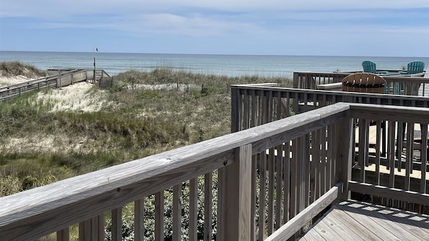 A wooden deck with a view of the beach and ocean. - 38 Piece Of Heaven Studio Bedroom Condo by RedAwning (Hatteras)