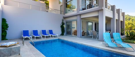 Seasonal outdoor pool, pool loungers