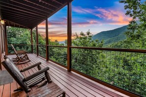 A wooden deck with a view of a mountainous landscape. - Ali's Dream 3 Bedroom Cabin by RedAwning (Sevierville)