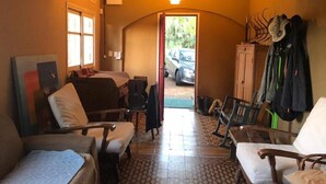 A compact room with a bed, two chairs, a cabinet, and a door leading outside. - 2 bedroom house in toledo (Toledo)