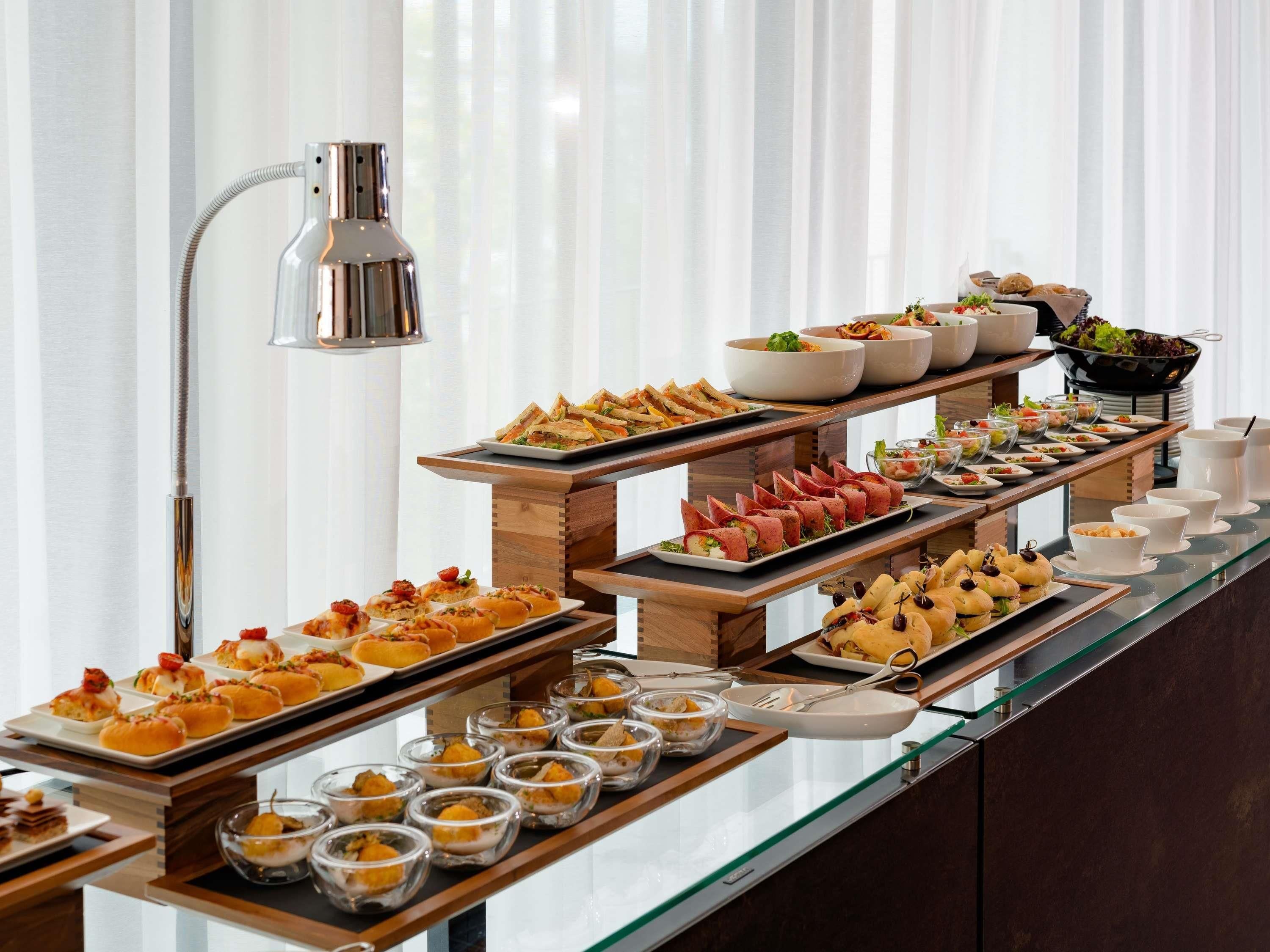A buffet with various food items and a lamp.