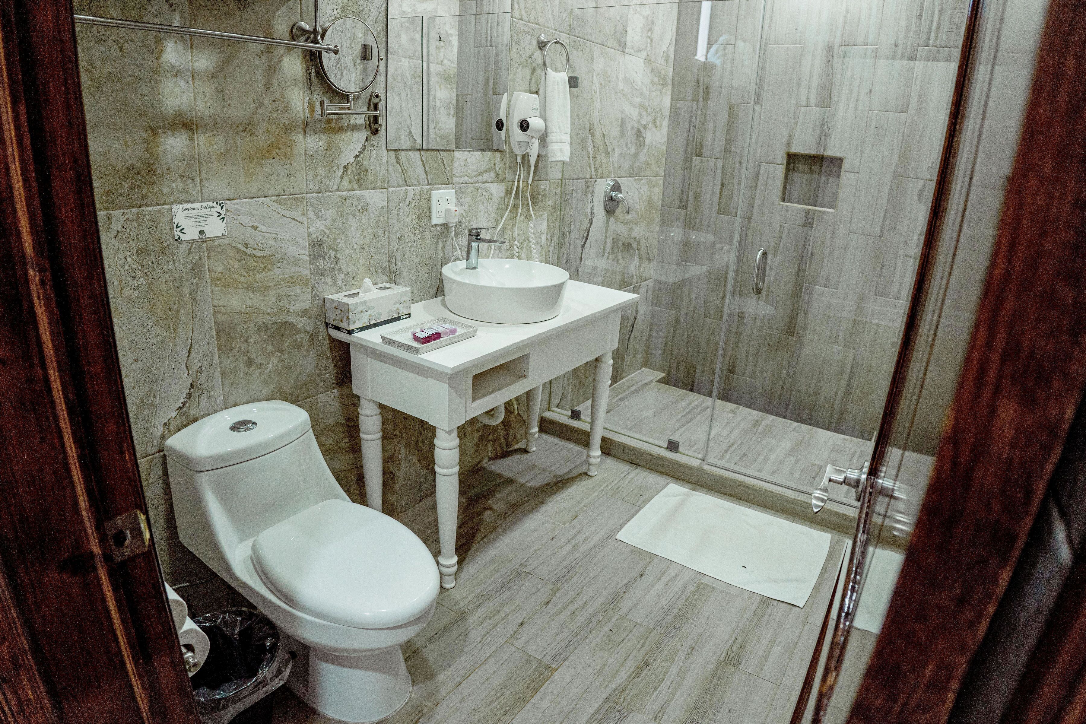 deluxe quadruple room | bathroom | shower, rainfall showerhead, hair dryer, towels