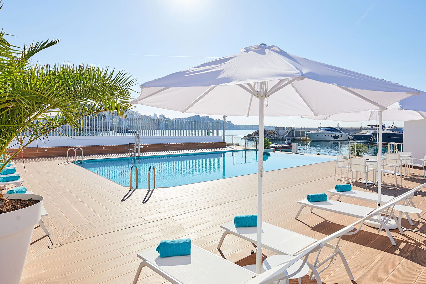 Seasonal outdoor pool, open 10:00 AM to 8:00 PM, pool umbrellas