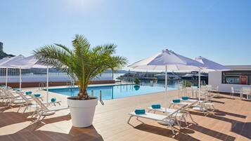 Seasonal outdoor pool, open 10:00 AM to 8:00 PM, pool umbrellas