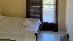 A hotel room with a bed, a window with curtains, a wall-mounted picture, and a ceiling light. - Villa Olympia Skafidia beach (Skafidia Pirgos ilias)