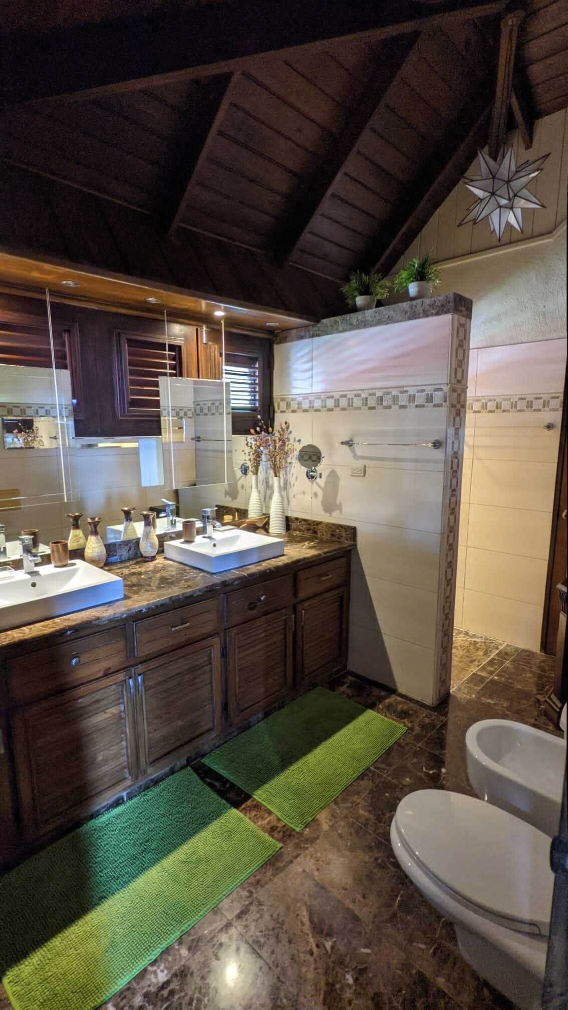 Une cuisine moderne avec un plafond en bois, un meuble-lavabo à deux vasques et un réfrigérateur.