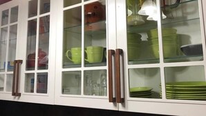 A kitchen with white cabinets, a microwave, a toaster, and a coffee maker. - DAGWOOD: 1 Bedroom Space T3 (Fort McMurray)
