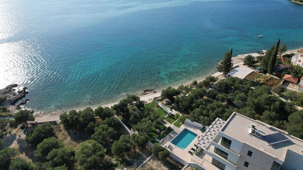 An aerial view of a coastal property with a swimming pool, a beach, and surrounding greenery. - Hedera Estate, Villa Hedera XV (Slano)