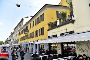 A street with outdoor seating at a Japanese restaurant.