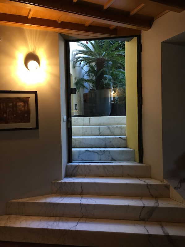 A staircase with marble steps leading to a door.