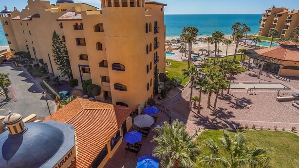 A hotel with a central tower, a pool area, and a beach view. - Princesa Resort D-509 Whispering Sands Great Ocean View Condo (Puerto Peñasco)