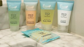Four bottles of Eco Botanics products on a bathroom shelf. - Modern Luxe Apartment - Close to City Center (Richmond)